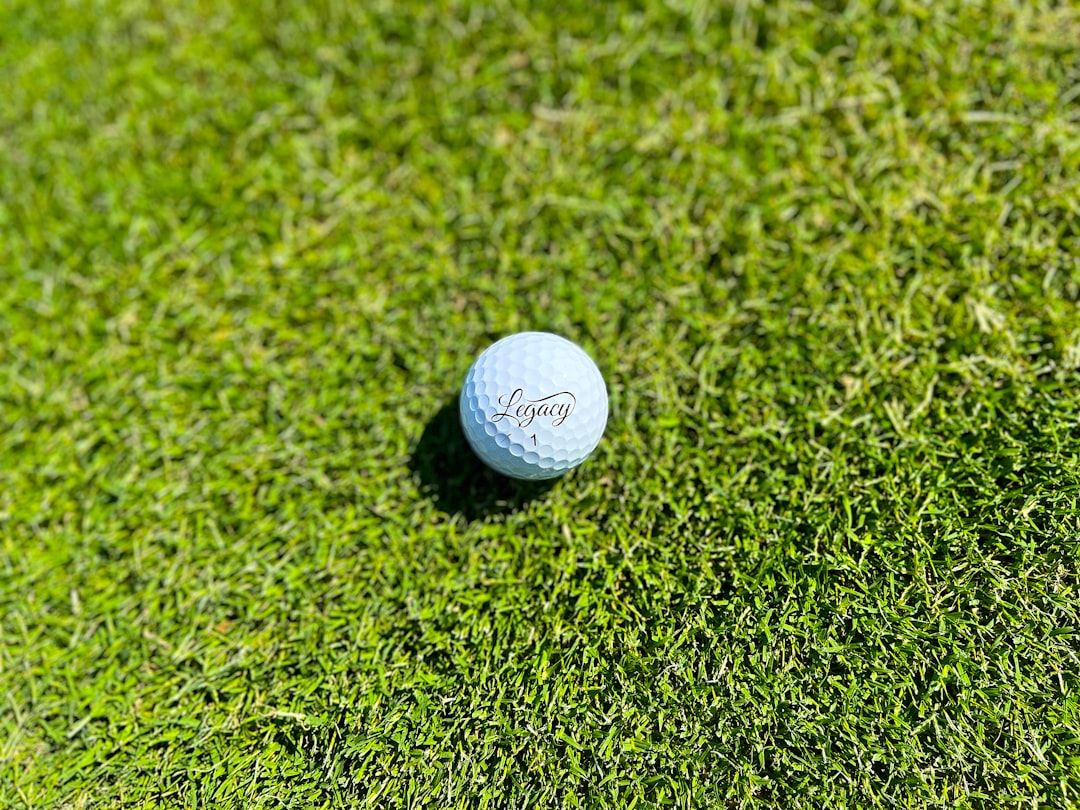 a golf ball sitting on top of a lush green field